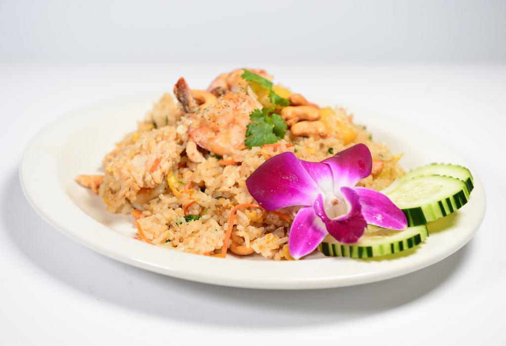 Pineapple Fried Rice · Fried rice with prawns, chickens, pineapple, and cashew nuts.