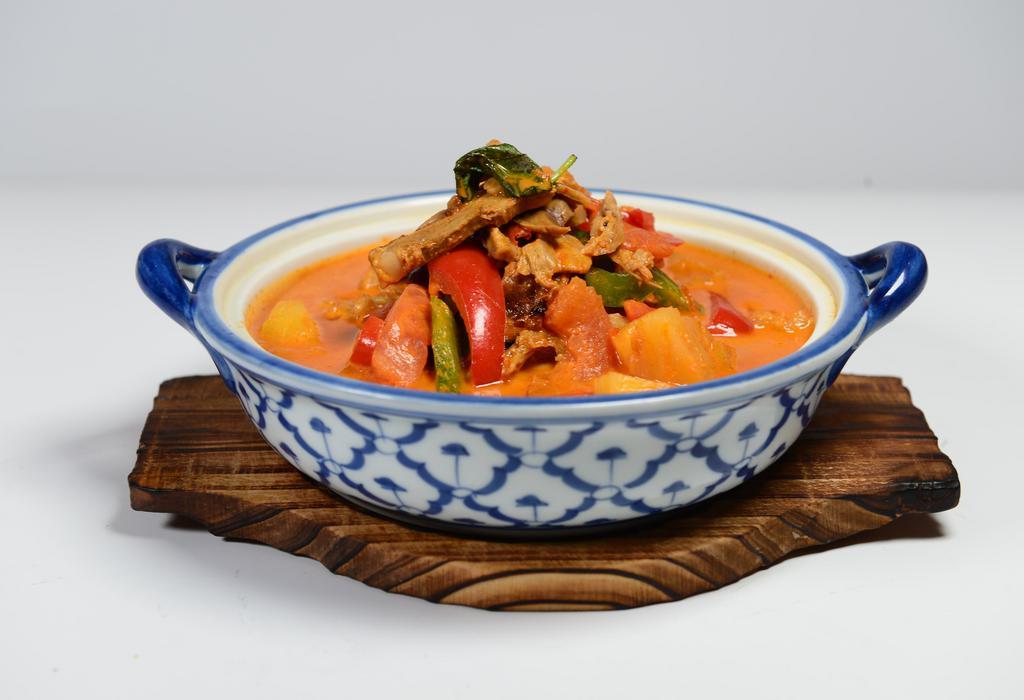 Red Curry Duck · Roast duck in red curry with coconut milk, tomatoes pineapples, bell peppers, and basil.