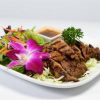 Moo Yang · Pork, marinated, and grilled. Served with sweet chili sauce.