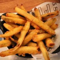 Pickle Fries · Gluten friendly dish. Coated in masa, fried crispy and dusted with old bay. Served with garl...