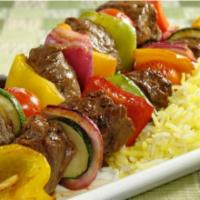 Beef Kabob Plate · Sizzling beef kabob over a bed of rice, with a side of salad, hummus and pita bread.