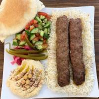 Ground Beef Kabob Combo · 2 beef kabob skewers over a nice size portion of rice, with green salad, a side of hummus an...