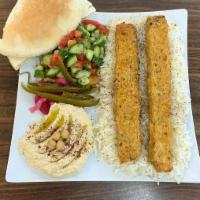 Chicken Kabob Combo · 2 chicken kabob skewers over a good portion of rice, green salad, and a side of hummus with ...
