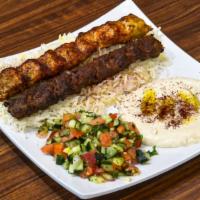 Chicken & Beef Kabob · 1 chicken kabob and 1 beef kabob over a good portion of rice, Green salad, and a side of hum...