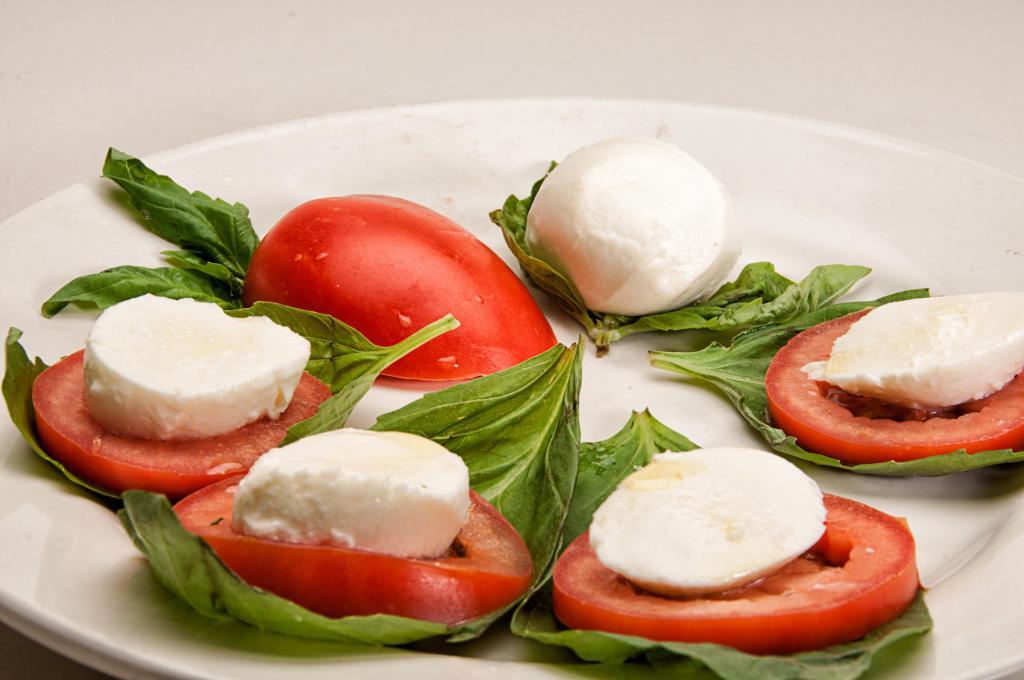 Caprese Salad · Basil, plum tomatoes, fresh mozzarella cheese, olive oil, balsamic vinegar and salt and pepper. 