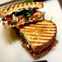 Venetian Panini  · Smoked Salmon , hot pepper cream cheese spread , arugula , roasted peppers , red onions . 