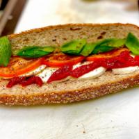 The Caprese Sub · Fresh mozzarella, roasted red peppers, tomatoes, and fresh basil. Topped with lettuce, onion...