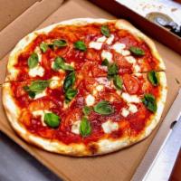 Caprese Pizza · Homemade fresh mozzarella, tomatoes, and fresh basil.