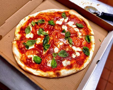 Caprese Pizza · Homemade fresh mozzarella, tomatoes, and fresh basil.