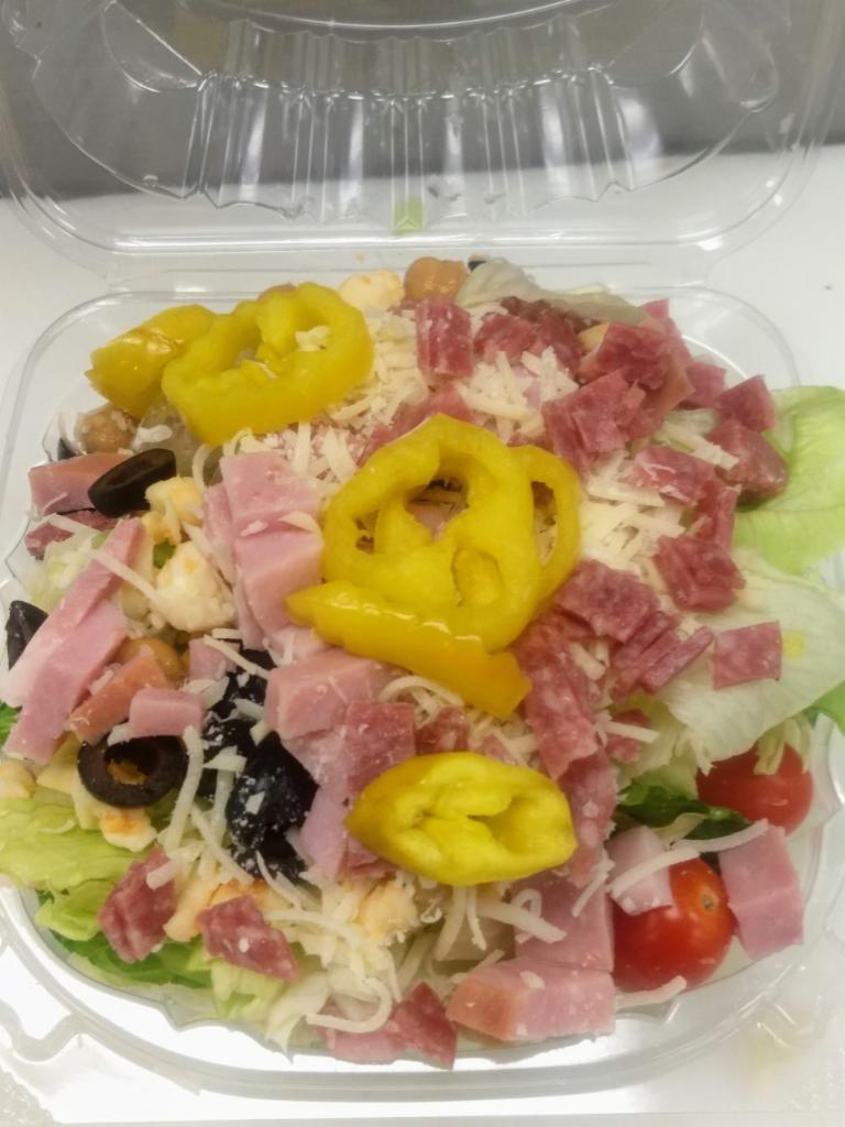 Chopped Italian Salad · Antipasto. Fresh mixed greens, tomatoes, chick peas, salami, ham, black olives, banana peppers, red onions, mozzarella & parmesan cheese, servedd with thin baked bread pieces with Parmesan and butter garlic. Greek dressing.