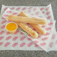 3 Breadsticks and 1 Dip · One of our signature items! Crispy-on-the-outside, soft-on-the-inside, and perfect with pizz...