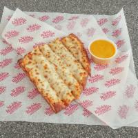 4 Cheesy Stix and 1 Dip · Pizza dough covered with our buttery garlic sauce, then topped with mounds of real cheese ma...