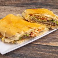 Pan con Bistec · A delicious steak sandwich with Swiss cheese, caramelized onions, fresh lettuce, tomatoes, m...