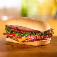 BBQ Smoked Stacker Sandwich · Honey Baked Ham, bacon, cheddar cheese, lettuce, tomato, red onion and smoky BBQ sauce on ci...