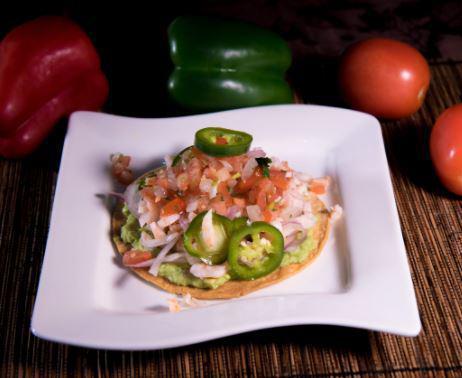 Tostada · Beans, lettuce, tomato, onions, avocado, sour cream, and grated cheese on top, jalapeno upon request. Frijol, lechuga, tomate, cebolla, aguacate, crema agria y queso molido arriba. Jalapeno al gusto.
