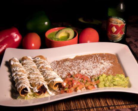 Flauta · 3 tortillas rolled and fried, stuffed with chicken or steak. Covered with sour cream and grated cheese. Served with beans, guacamole and pico de gallo.
