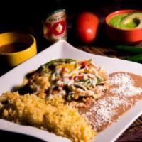 Fajitas Oaxaquenas · Chicken or steak fajitas sauteed with tomatoes, onion, green, and red pepper and bedded on a...