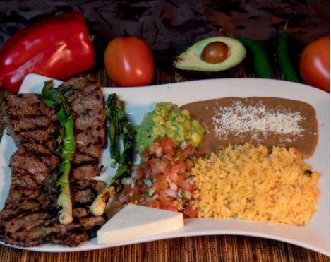 Carne Asada · Steak served with rice, beans, pico de gallo, guacamole, and green onions. Acompanada con arroz, frijol, pico de gallo, guacamole y cebollines.
