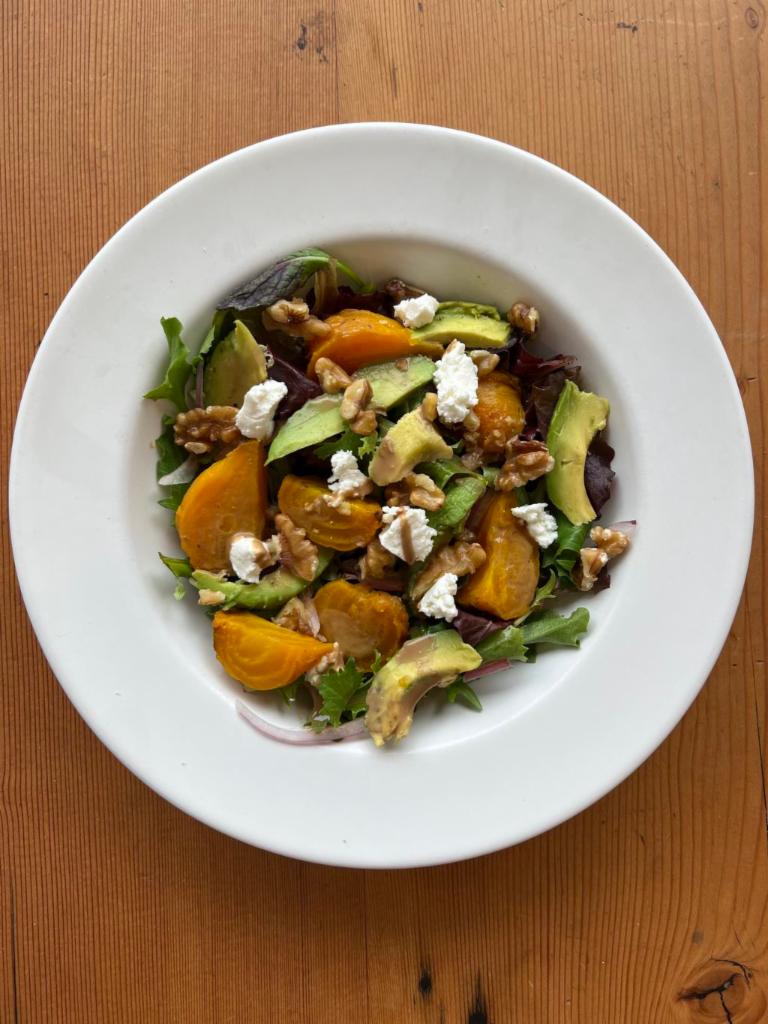 Golden Beet Salad  · Golden beets, walnuts, avocado, and red onion tossed with mixed greens in a balsamic vinaigrette topped with goat cheese.