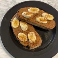 Nut Butter Honey Toast · Toasted French batard with peanut or almond butter topped with banana slices, honey, cinnamo...