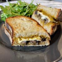 Portobello Sandwich and a Green Side Salad · Marinated and roasted portobello mushrooms with sautéed onions, cheese and a sun-dried tomat...