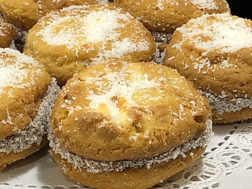 Lemon/White Chocolate/Dulce de Leche Cookie Sandwich  · (A pair of chewy lemon cookies studded with white chocolate chunks, filled with Dulce de Leche and rolled in Coconut.