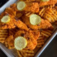 TW'S Hot Chicken Tenders · Nashville-style hot chicken tenders with a Tex-Mex twist.  Served over waffle-cut fries and ...