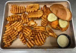 TW'S Hot Chicken Sandwich · Nashville-style hot chicken sandwich with a Tex-Mex twist.  Topped with pickles and served with a side of waffle-cut fries and Jalapeno ranch. 