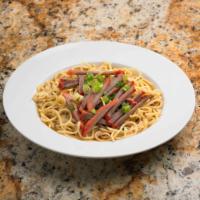 BBQ Pork Noodle Soup · BBQ pork strips over egg noodles in a hot broth sprinkled with fresh green onions.