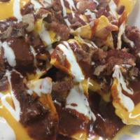 Loaded Nachos · Crunchy nacho chips, smothered in melted cheese, covered with a heap of chill crumbled bacon...