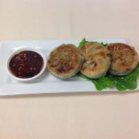 10. Gui Chai · Pan fried chive dumplings served with spicy sweet soy sauce.