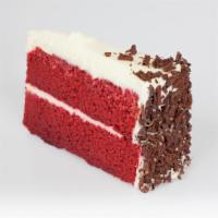 Red Velvet Cake · Double-layered Red Velvet Cake topped with Cream Cheese Icing and Chocolate Curls.