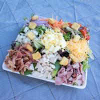 Cobb Salad · A bed of mixed greens topped with Ham, Turkey, Bacon, Shredded Cheese, Bleu Cheese, Red Onio...