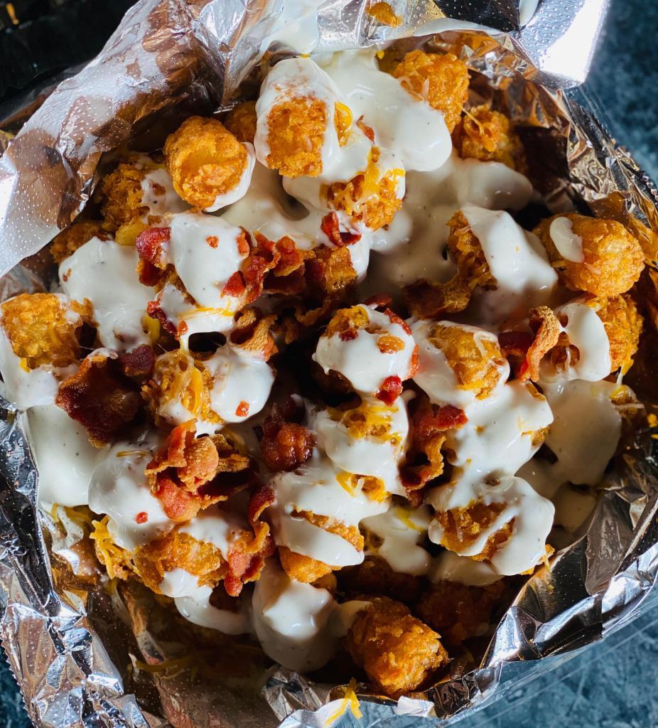Joco’s tater tots  · Tater tots basket topped with cheese, bacon, and ranch dressing. 