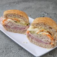 Owners Special Sub · Oven roasted turkey, deluxe ham and Austrian Swiss topped with kosher dill pickle and our ho...