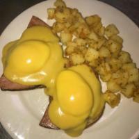 Eggs Benedict Breakfast · 2 poached eggs atop baked ham and an English muffin with Hollandaise sauce, served with cup ...