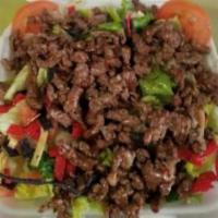 Grilled Steak Salad · Romaine lettuce, and tri-color tortilla strips add grilled onions. Choose dressing. Add onio...