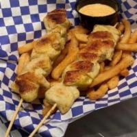 Chicken Skewers · Homemade seasoned grilled chicken breast. Comes with fries, and gauchos sauce. Add onions, e...