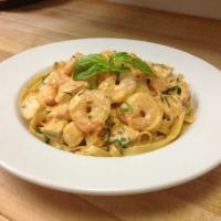 Fettuccine Aurora · Grilled chicken and shrimp tossed in a blush cream sauce. Served with garlic knots.