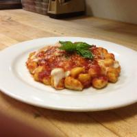 Gnocchi Caprese · Potato pasta tossed in marinara sauce and topped with melted provolone cheese. Served with g...
