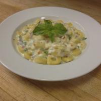 Tortellini Della Mamma · Cheese filled pasta hats tossed with imported ham, green peas, Alfredo sauce and covered wit...