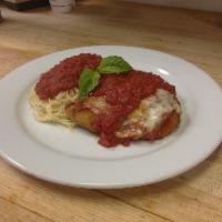 Chicken Parmigiana · Breaded and topped with our homemade marinara sauce and melted provolone, served with spaghe...