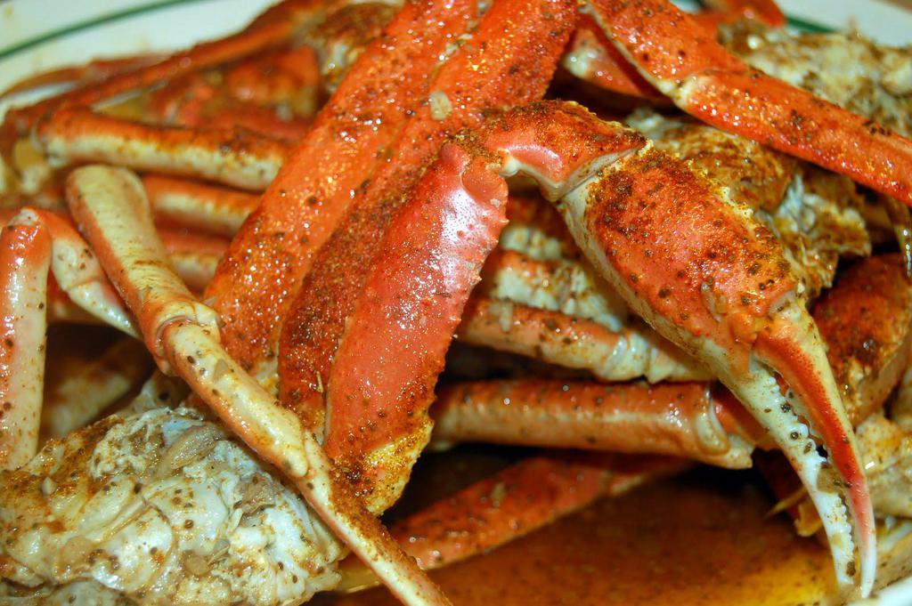 Snow Crab Legs · Snow crab, also known as queen crab, are found in the North Atlantic and North Pacific, preferring deep, cold-water conditions.  Although found in snowy ocean environments, they get their name from the snow-white colour of their meat. As their name suggests, they are closely related to the larger king crab.

Snow crab usually have a brown to light red protective shell and a yellow or white abdomen. They have five pairs of spider-like legs; four pairs of walking legs and one pair of claws. Their eyes are green or greenish blue. The snow crab has a sweet, slightly briny flavor and a firm texture. Snow crabmeat breaks off in long pieces, and is often shredded, almost like corned beef.