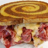 The Reuben Sandwich · 1/2 lb. of corned beef brisket and Swiss cheese with 1000 Island dressing and sauerkraut ser...