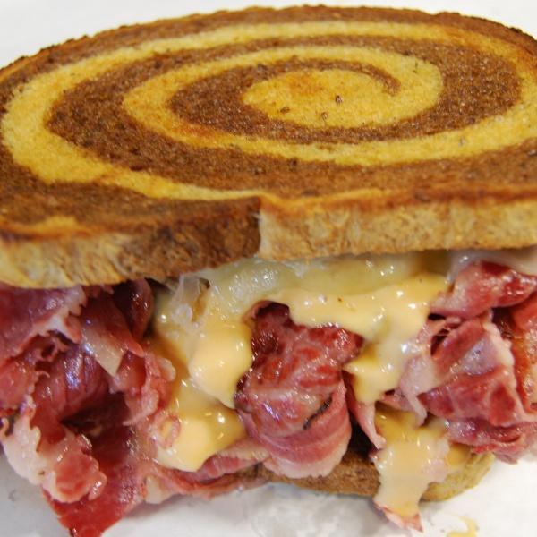 The Reuben Sandwich · 1/2 lb. of corned beef brisket and Swiss cheese with 1000 Island dressing and sauerkraut served on grilled marble rye bread.