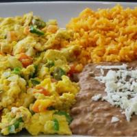 Huevos A La Mexicana · Scrambled eggs with tomato, onion, cilantro and jalapenos. Your choice of flour or corn tort...