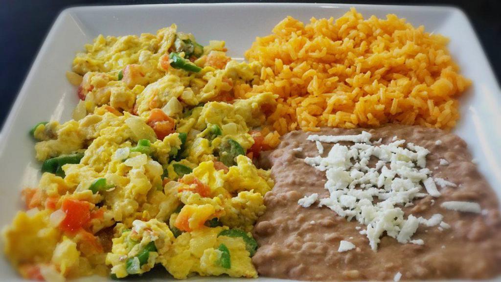 Huevos A La Mexicana · Scrambled eggs with tomato, onion, cilantro and jalapenos. Your choice of flour or corn tortillas.