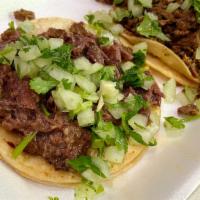 Cabeza Mini Taco · Beef head mini taco topped with onion and cilantro. Served with grilled onions and jalapeno ...