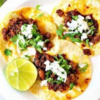 Chorizo Mini Taco · Chorizo mini taco topped with onion and cilantro. Served with grilled onions and jalapeno on...
