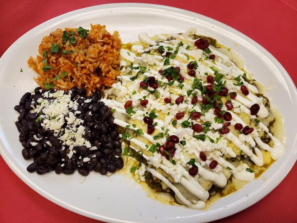 Enchiladas Suiza · corn tortilla, chicken tinga, salsa verde, manchego and jack cheeses, lime crema, pomegranate seeds, queso fresco, cilantro

served with spanish rice and braised black beans, cotija & cilantro